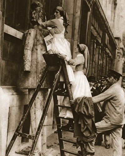 A hospital nurse reversing her usual role: hammering the enemy at Stepney by English Photographer